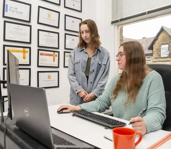 Two team members discussing recent marketing changes.