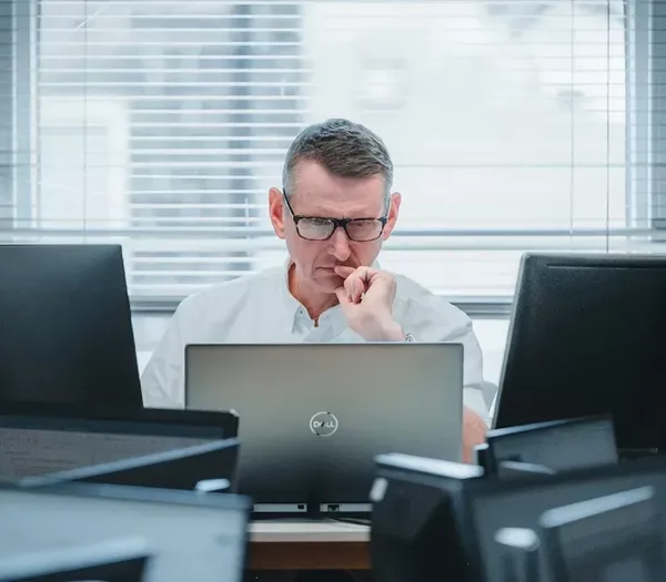 Peter working on multiple computers.