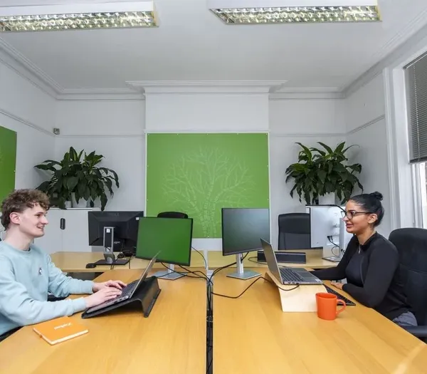 Two team members discussing AI overviews.