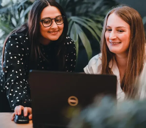 Two team members discussing online content.