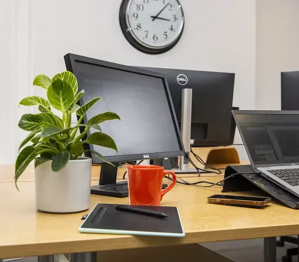 Desk with laptops in Zelst office.