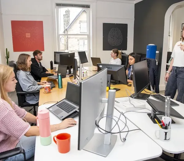 Zelst team sat around desks in the office.