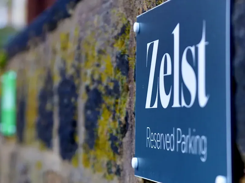Zelst Reserved Parking sign on mossy brick wall
