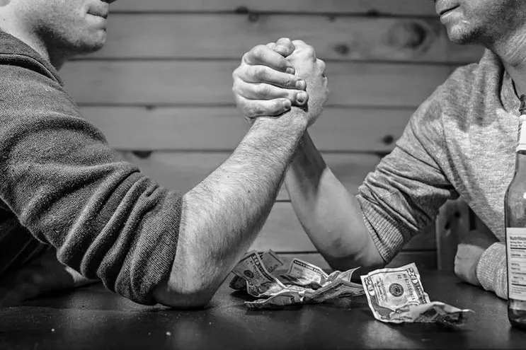 Arm wrestle representing a competitor analysis.